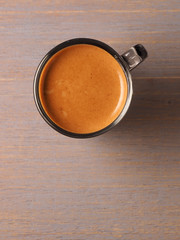 Cup of hot espresso coffee on wood board