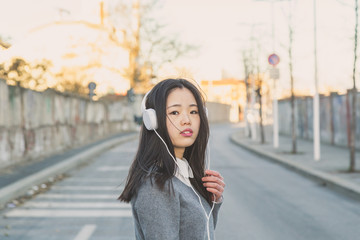 Young beautiful Chinese girl with headphones