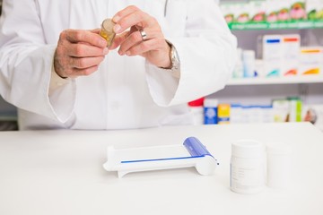 Pharmacist holding jar of medicine