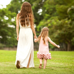 Obraz premium Young mother and her toddler girl have fun