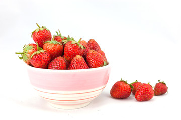 Small white bowl filled with red strawberries
