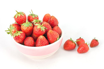Small white bowl filled with red strawberries