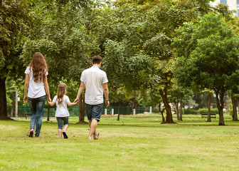 Family walk in the park, happy at sunset in Bangkok, Thailand.