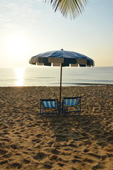 beach canvas beds with blue and white umbrella