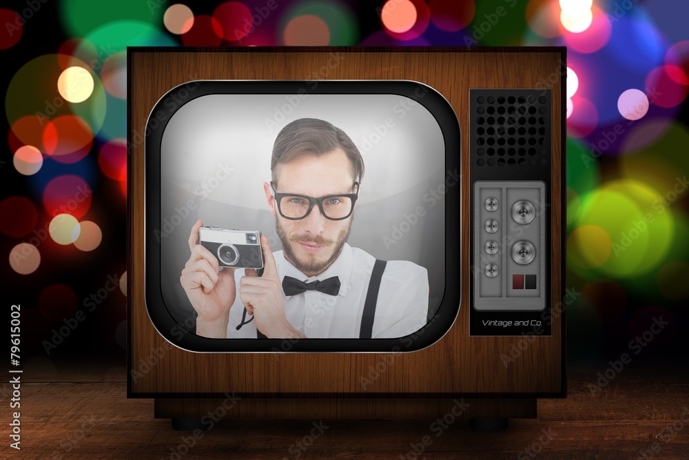 Poster composite image of geeky hipster holding a retro camera