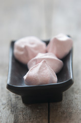 Meringue cookies in bowl close up