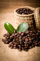 pile of fresh beans and green leaves and spoon in jar