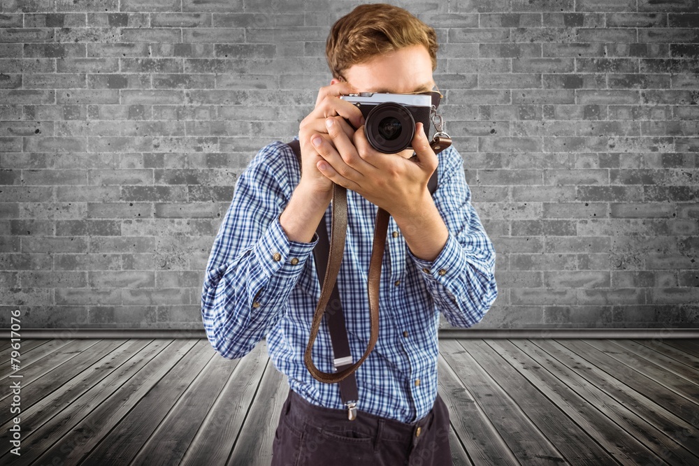 Aufkleber Composite image of geeky hipster holding a retro camera