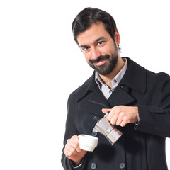 Brunette man holding a cup of coffee