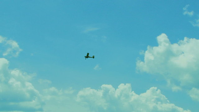Small Propeller Airplane Flying High In the Sky