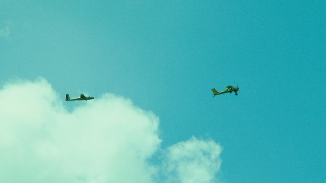 Glider Towing Plane High In the Sky