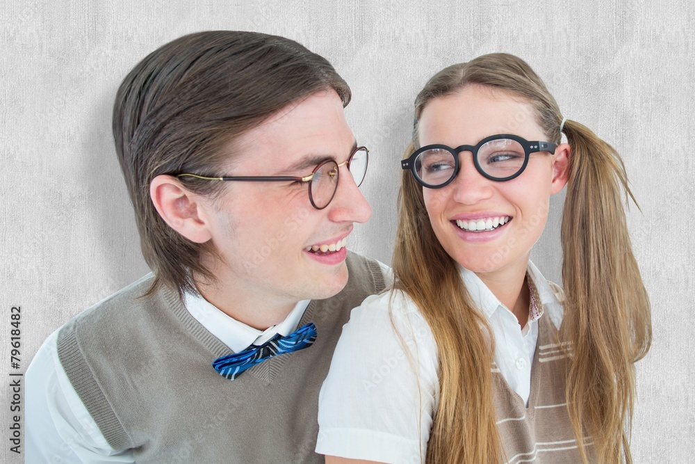 Poster Composite image of geeky hipster couple smiling at each other