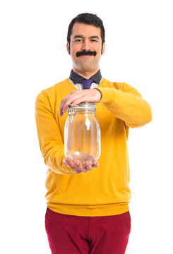 Man With Moustache Holding An Empty Glass Jar