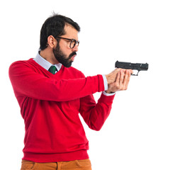 Fototapeta na wymiar Hipster man shooting with a pistol