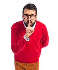 Hipster man making silence gesture