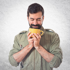 mechanic holding a cup of coffee