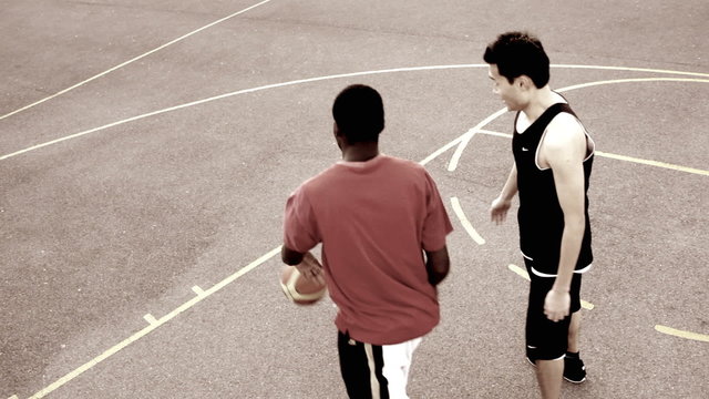 Male basketballer dribbling and dunking
