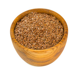 flax seed in a wooden bowl isolated on white