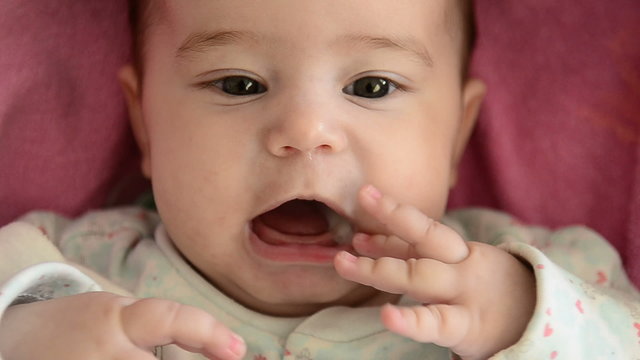 Close-up of baby girl's face who is babbling