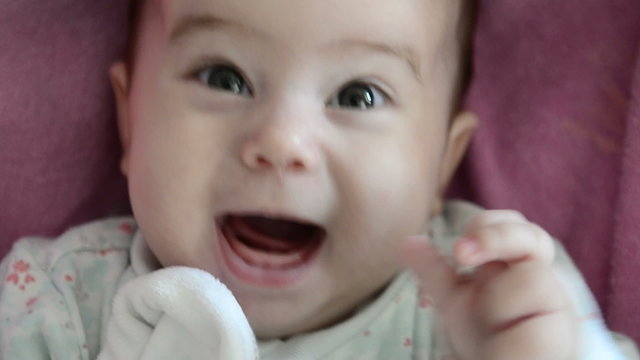 Close-up of baby girl's face who is babbling