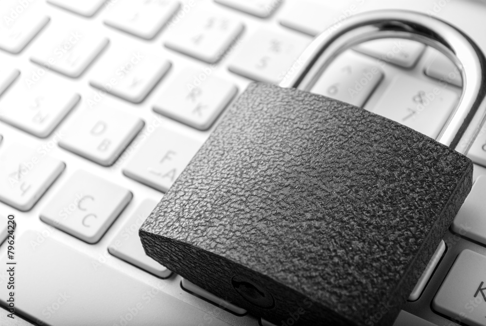 Poster padlock lying on the computer-keyboard