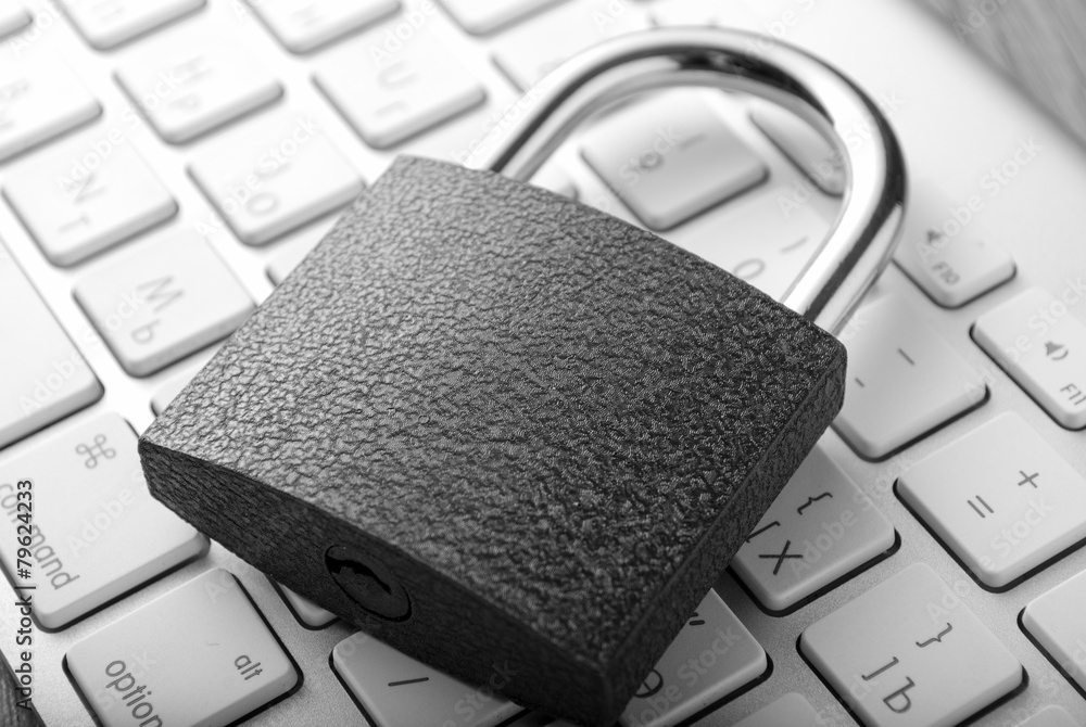 Poster padlock lying on the computer-keyboard