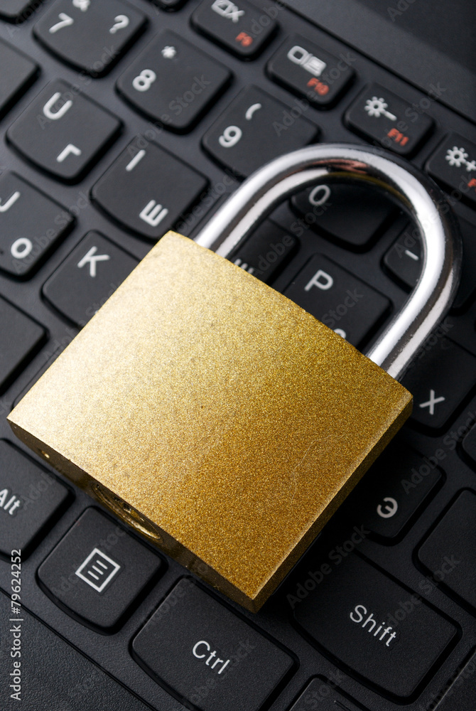 Poster padlock lying on the computer-keyboard