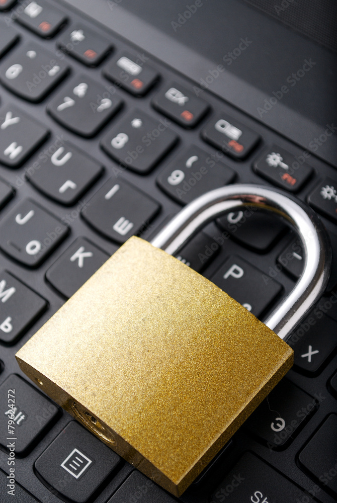 Poster padlock lying on the computer-keyboard