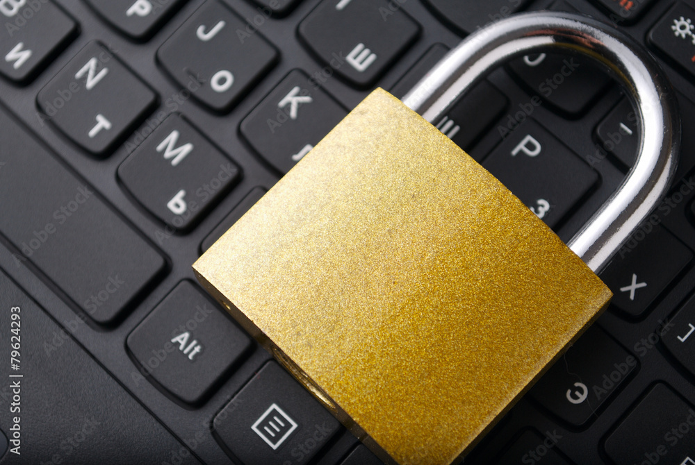 Poster padlock lying on the computer-keyboard