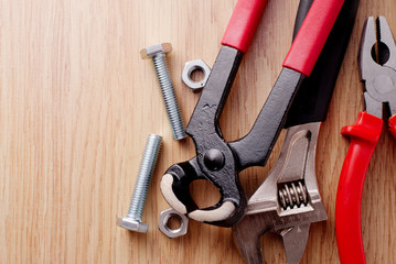 Bolts and nuts with a set of plumbing tools