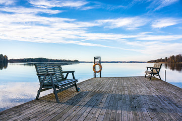 Fototapeta na wymiar jetty with benches at the lake