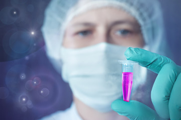 Scientist or tech holds liquid biological sample