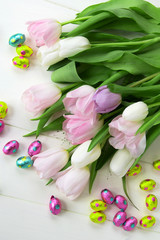 Obraz na płótnie Canvas Bunch of Tulips and Chocolate Easter Eggs