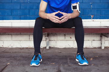 young male athlete sitting on the bench