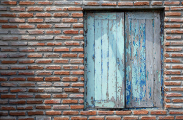 brick and old window blue color with shadow and light.