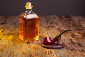 Bottle of brandy and tobacco pipe