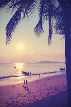 Retro instagram style filtered picture of beach at sunset, Thailand.