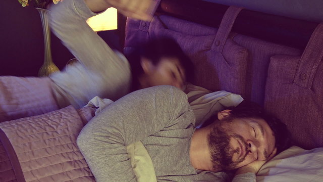 Man in bed not able to sleep with anonying girlfriend