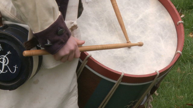 Drummer drums during a revolutionary war battle reenactment