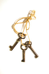 Three old keys tied with a rope on a white background