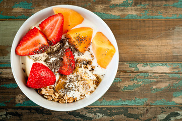 Healthy breakfast of muesli strawberries and melon.