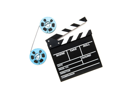 Vintage 8mm blue movie reels and clapper board white background