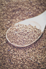 Granules of instant coffee in wooden spoon