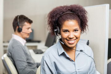 Smiling Female Customer Service Representative In Office