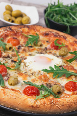 Delicious Italian pizza with egg in a center