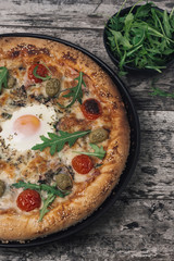 Delicious Italian pizza on an old rustic wooden table