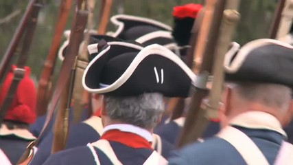 Soldiers march during a revolutionary war battle reenactment