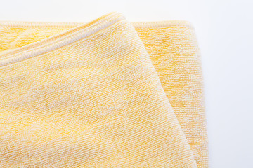 Fototapeta na wymiar Clean yellow towel on a white background