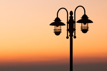 silhouette lamp on sunset background