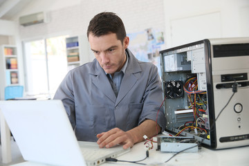 Fototapeta Technician fixing computer hardware obraz